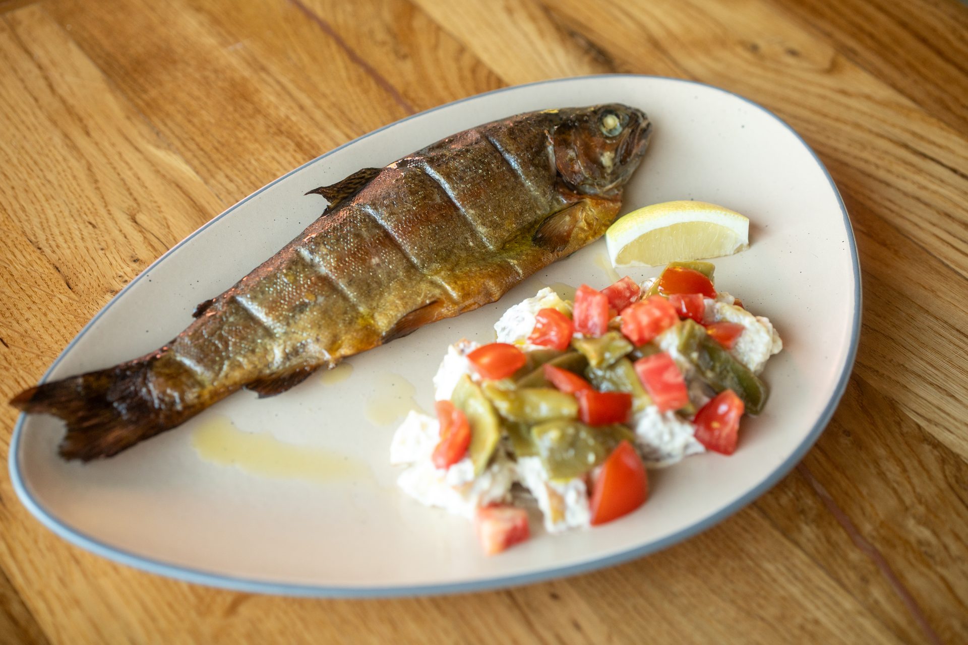 Smoked trout with horseradish cream, cherry tomatoes and seasonal vegetables