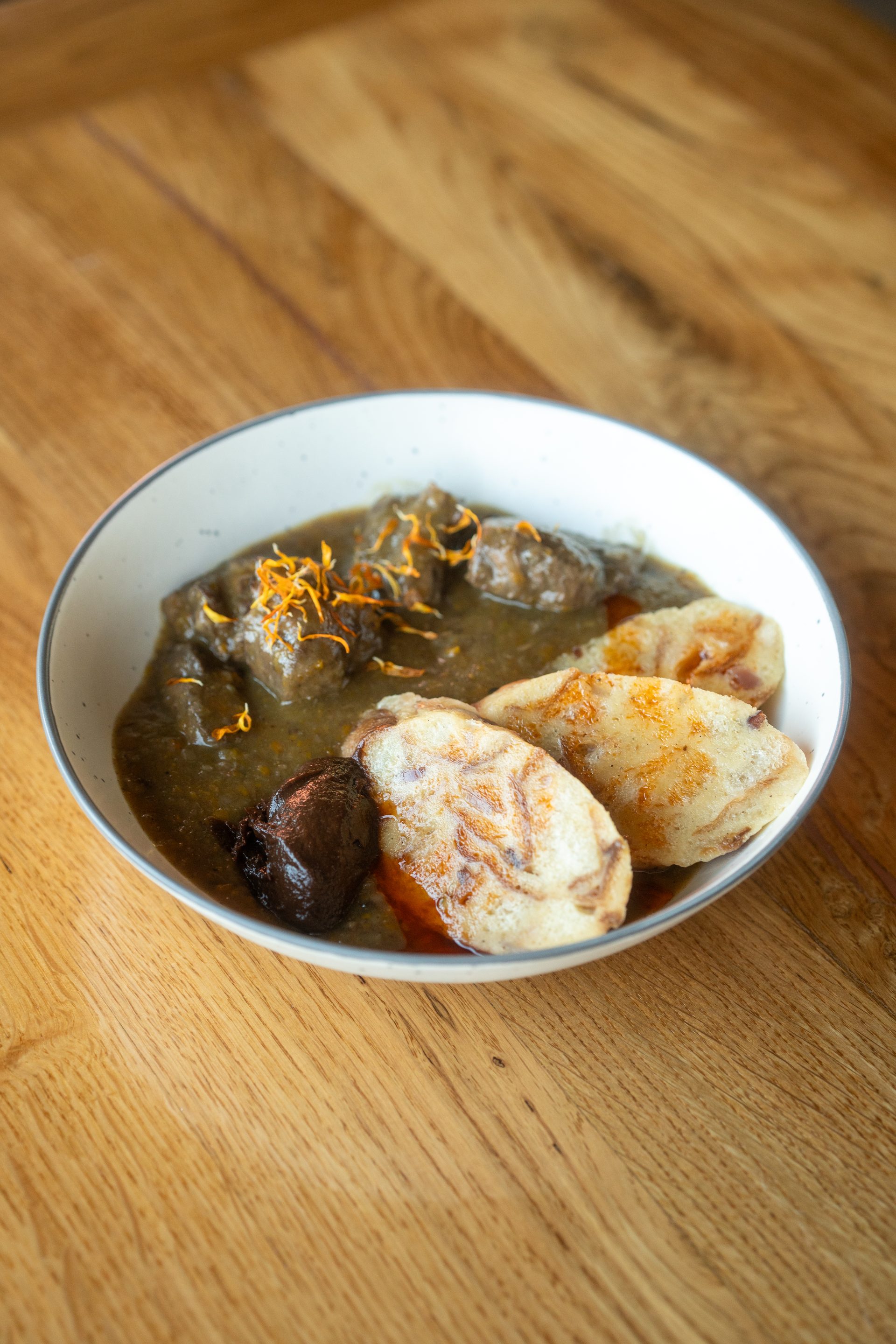 Wild game goulash — wild boar and venison with bread dumplings
