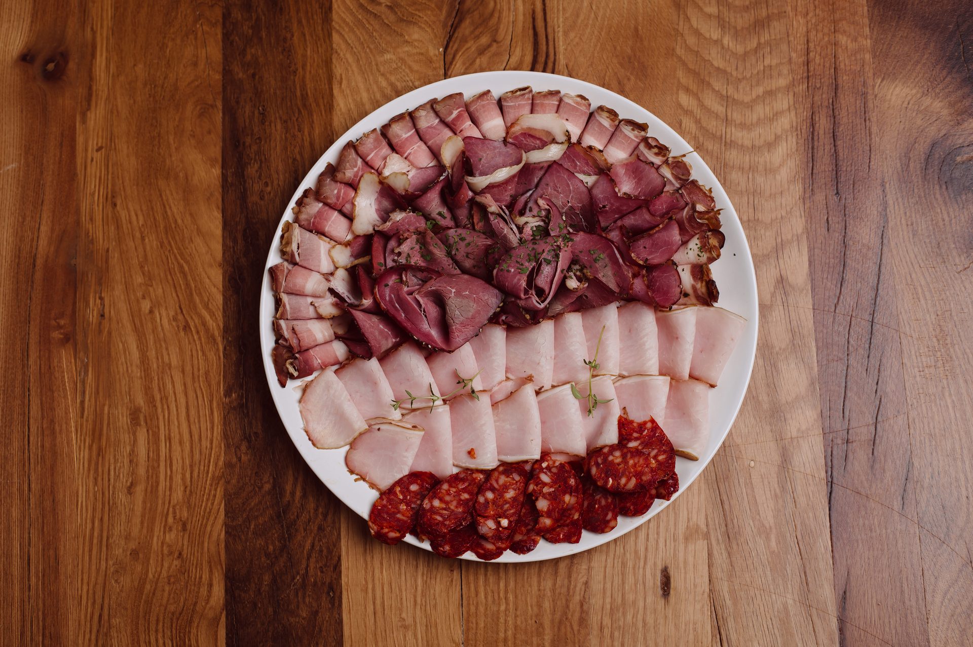 House charcuterie platter — smoked meats, cured sausages, air-dried ham