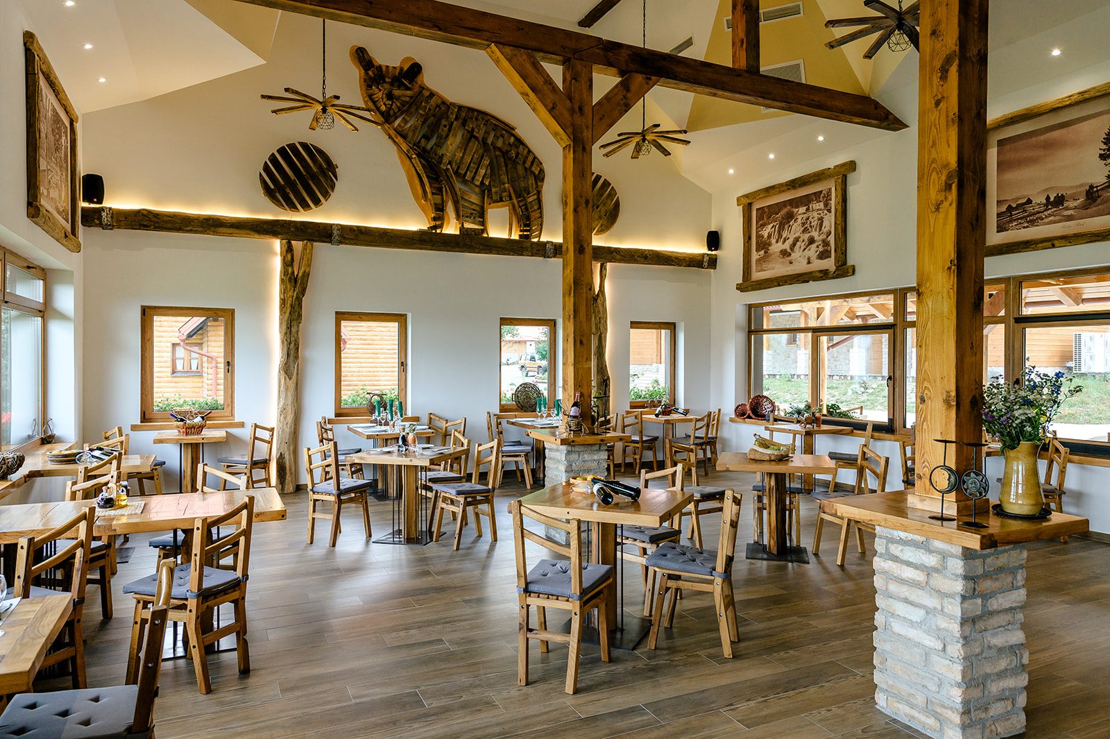 La Ursula main dining room with wild boar sculpture and wooden beams