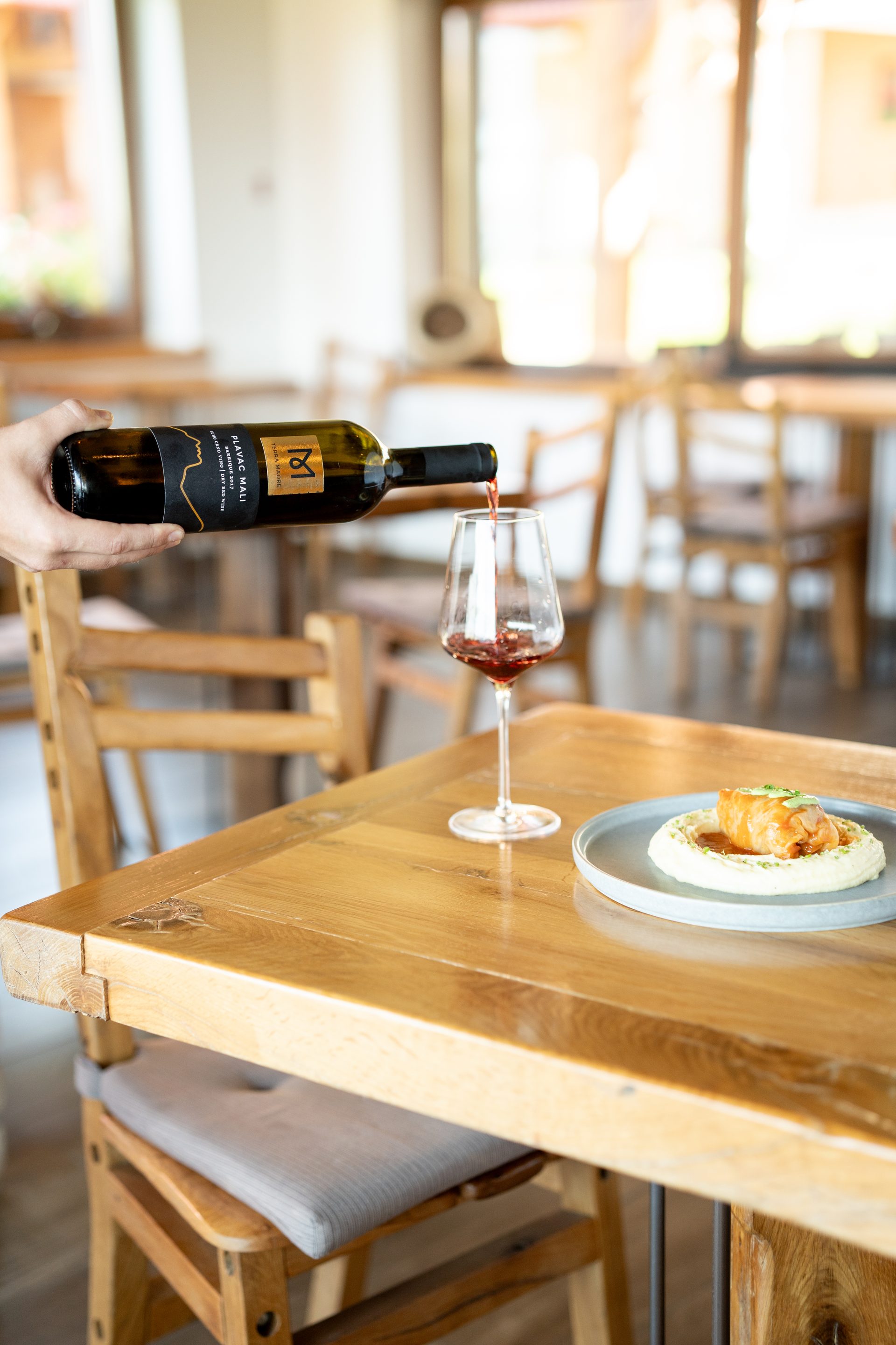Plavac Mali wine poured at La Ursula table with wild game dish