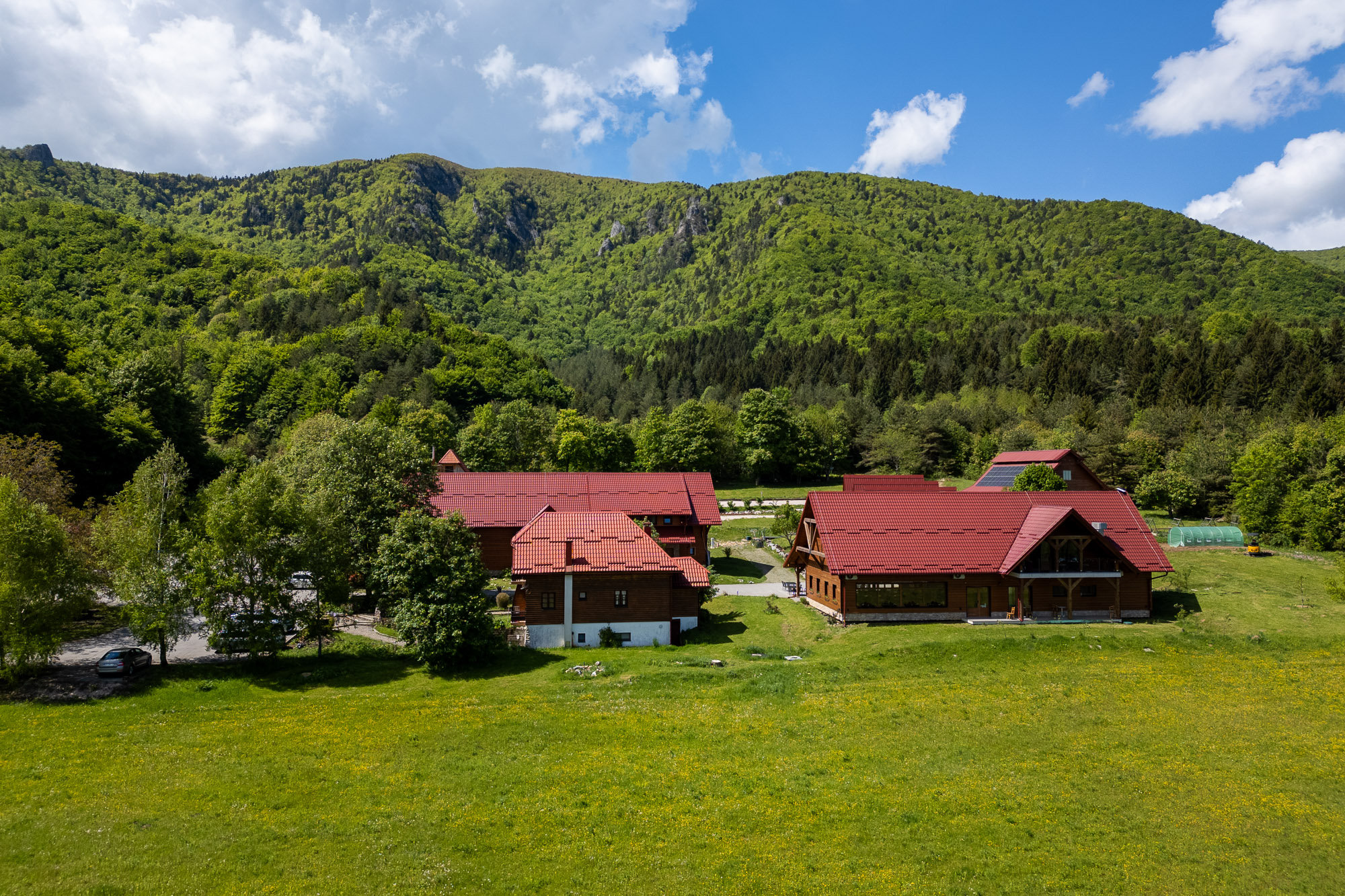 Aerial drone view of Mrzlin Grad and La Ursula restaurant surrounded by Lika forest near Plitvice Lakes